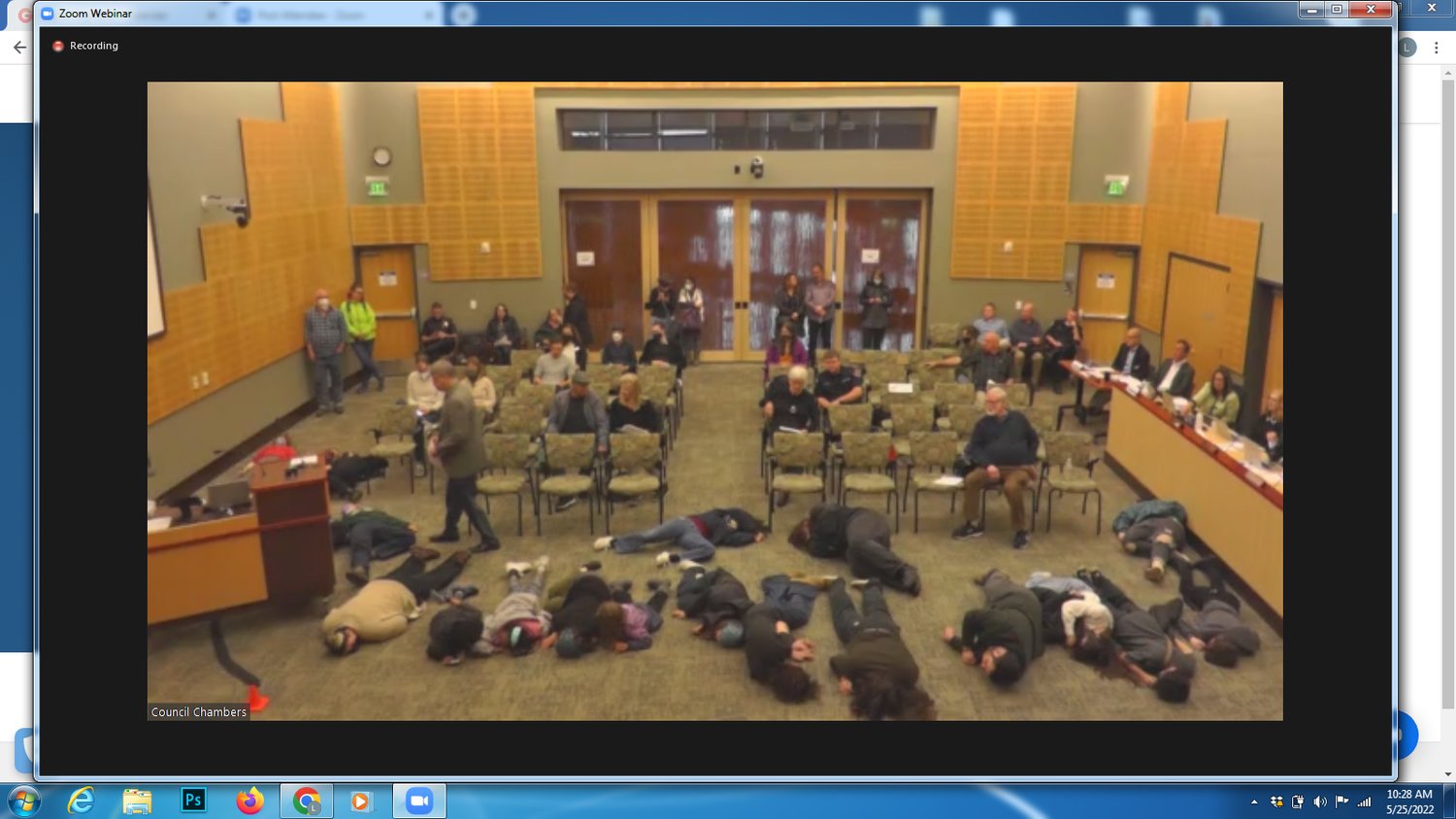 The youth laid still on the floor throughout the public comment segment.